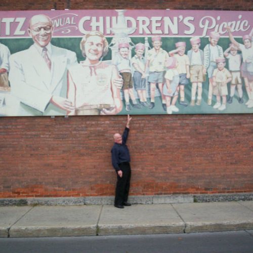 Commemorative paintings on the sides of several local buildings, Cornwall, Ontario, One of the Children at Mayor Horovitz Picnic